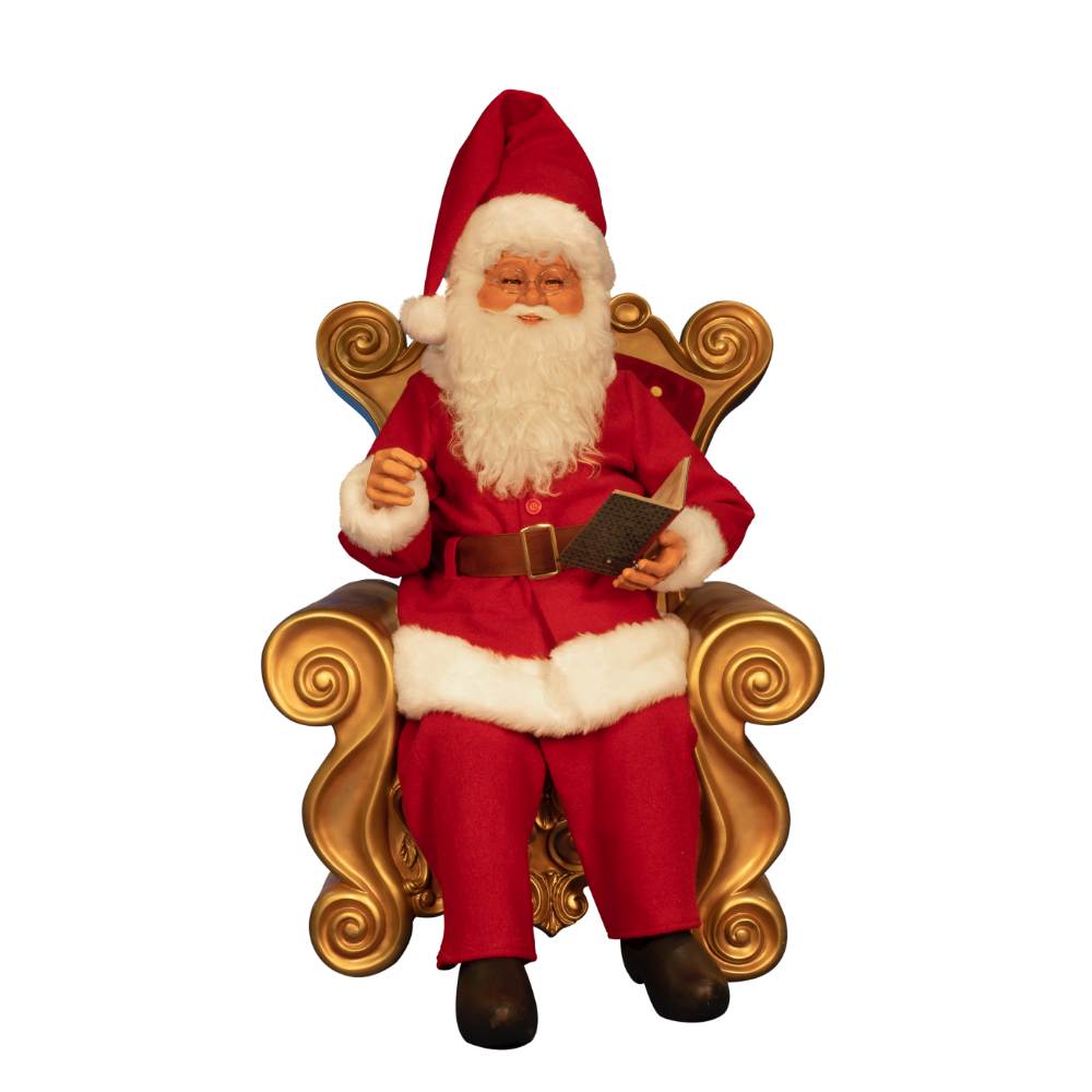 Santa Claus sitting in a chair, reading a book